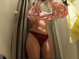 Uber-cute damsel unclothing in the fitting bedroom of the supermarket